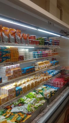 a display in a grocery store filled with lots of different foods and drinks on shelves