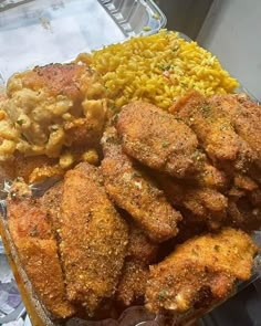 a plastic container filled with different types of food next to rice and other foodstuffs