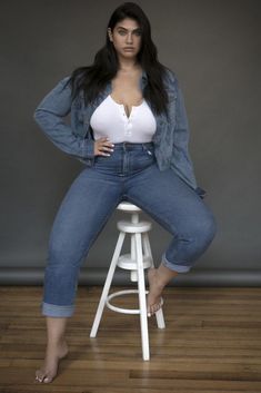 a woman sitting on top of a stool