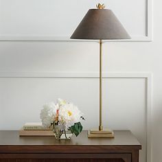 a table with a lamp and flowers on it