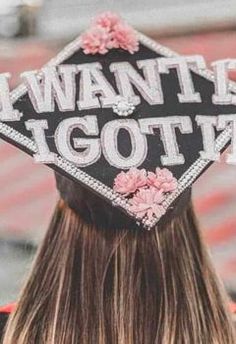 a woman wearing a graduation cap that says i want it got't