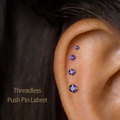 an ear with three different colored stones on it