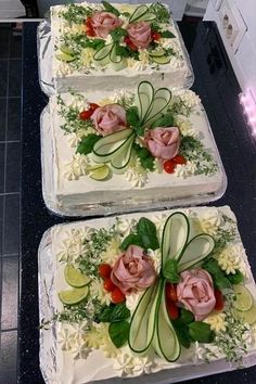 three square cakes with flowers and leaves on them