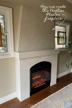 a living room with a fire place in the corner and a rug on the floor