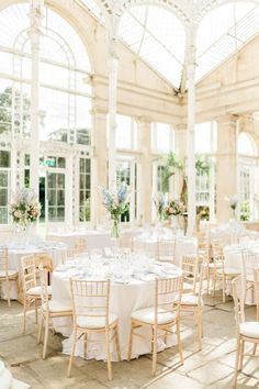 an indoor wedding venue with tables and chairs