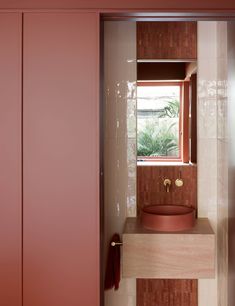 a bathroom with a sink and red cabinets