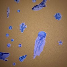 an image of blue jellyfish and other marine life on the wall in this room