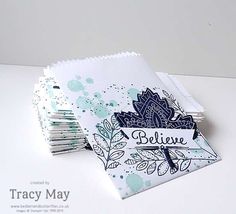 a stack of cards with the words believe on them and some papers stacked in front of it