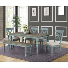 a dining room table with chairs and bench