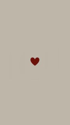 a red heart is in the middle of a gray background