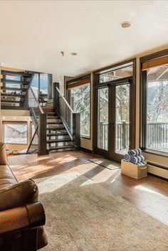 a living room with couches and stairs in it