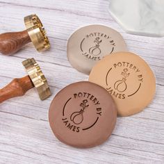 three different types of wooden stamps on a white table with wood handles and stampers