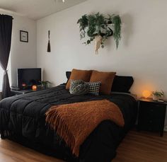 a bed room with a neatly made bed and wooden floors