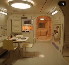 the interior of a space shuttle kitchen and dining area with table, chairs, microwave and oven