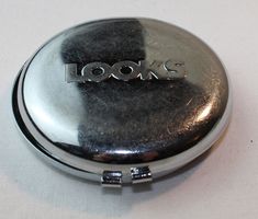 a compact mirror with the words looks on it