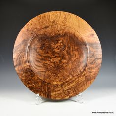 a wooden plate sitting on top of a white table