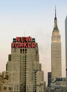 the new york city skyline is lit up in red