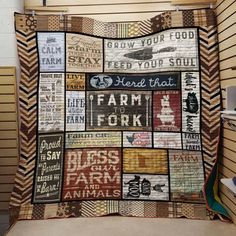 a quilt made to look like it has words on it and is hanging from the wall