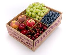 a box filled with lots of different types of fruit next to grapes and peaches