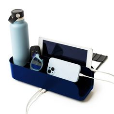 an ipod, cell phone and other electronics in a blue holder on a white background