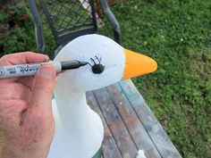 a person is painting a duck with marker