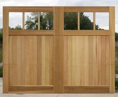 a wooden gate with two windows on each side