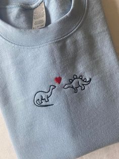 Dinosaurs In Love Embroidered Sweatshirt Embroidered Dinosaur Sweatshirt, Cute Embroidery Shirt Ideas, Matching Dino Hoodies Couple, Embroider Sweatshirts Ideas, Love Hoodie Design, Embroidery Designs Dinosaur, Cute Embroidery Designs On Hoodies, Embroidered Tshirt Mens, Dinosaur Present Ideas