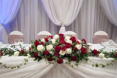 the table is decorated with white and red flowers