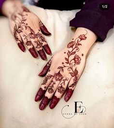 two hands with henna designs on them