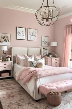 a bedroom with pink walls and white furniture