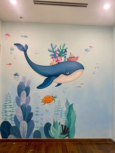 a room with a dolphin painted on it's wall and under the seaweed