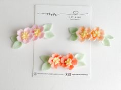 three flower clips on top of a card