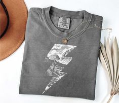 Western Cowgirl  Boho Desert Shirt Comfort Colors t-shirt, a fully customizable tee made 100% with ring-spun cotton. The soft-washed, garment-dyed fabric brings extra coziness to your wardrobe while the relaxed fit makes it an excellent daily choice. The double-needle stitching throughout the tee makes it highly durable while the lack of side-seams helps the shirt retain its tubular shape. .: 100% ring-spun cotton .: Medium fabric (6.1 oz/yd² (206.8 g/m .: Relaxed fit .: Sewn-in twill label Country Tshirt Ideas, Western Tees, Western T Shirts, Relaxed Fit T-shirt With Graphic Print For Western-themed Events, Trendy Tshirts Graphic Tees Western, Western Tee Shirts, Casual Western Outfits, Western Style Relaxed Fit Graphic T-shirt, Western Style Cotton T-shirt For Rodeo