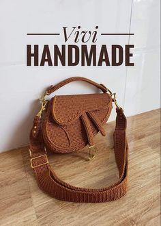 a brown purse sitting on top of a wooden floor