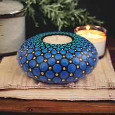 a candle is sitting on a napkin next to a potted plant and some candles