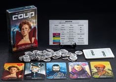 a group of card games sitting on top of a table next to a game box