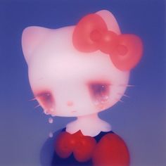 an image of a hello kitty doll with big eyes and red bow on her head