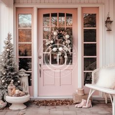 a pink front door decorated for christmas