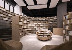 an empty library with bookshelves and chairs in the foreground, there is no image here to provide a caption for