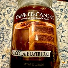 a jar of chocolate layer cake sitting on top of a table