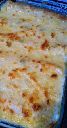 a casserole dish with cheese on top in a glass baking pan, ready to be eaten