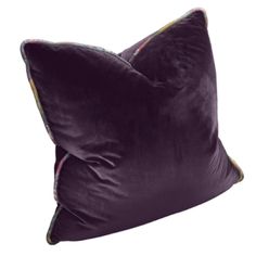 two velvet pillows with contrasting piping on the sides, one in red and one in purple