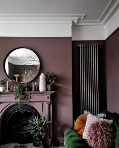 a living room filled with furniture and a fire place next to a mirror on the wall