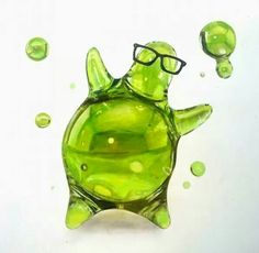 a green glass turtle with glasses on it's head and bubbles in the air