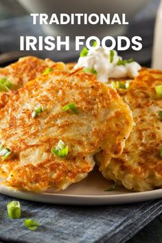 traditional irish food is served on a plate with sour cream and scallions in the background