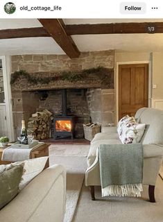 a living room filled with furniture and a fire place in the middle of it's fireplace