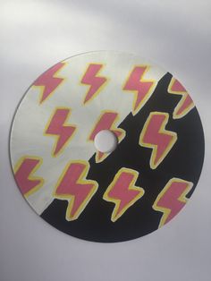 a disc with pink and yellow lightning stickers on it