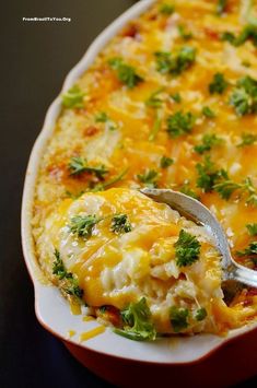 a casserole dish with broccoli and cheese on it is being eaten by a fork