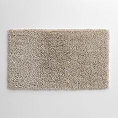 a white bathroom rug on a wall