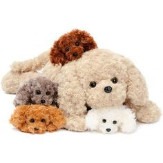 a group of stuffed animals sitting next to each other on a white surface with one dog and two puppies